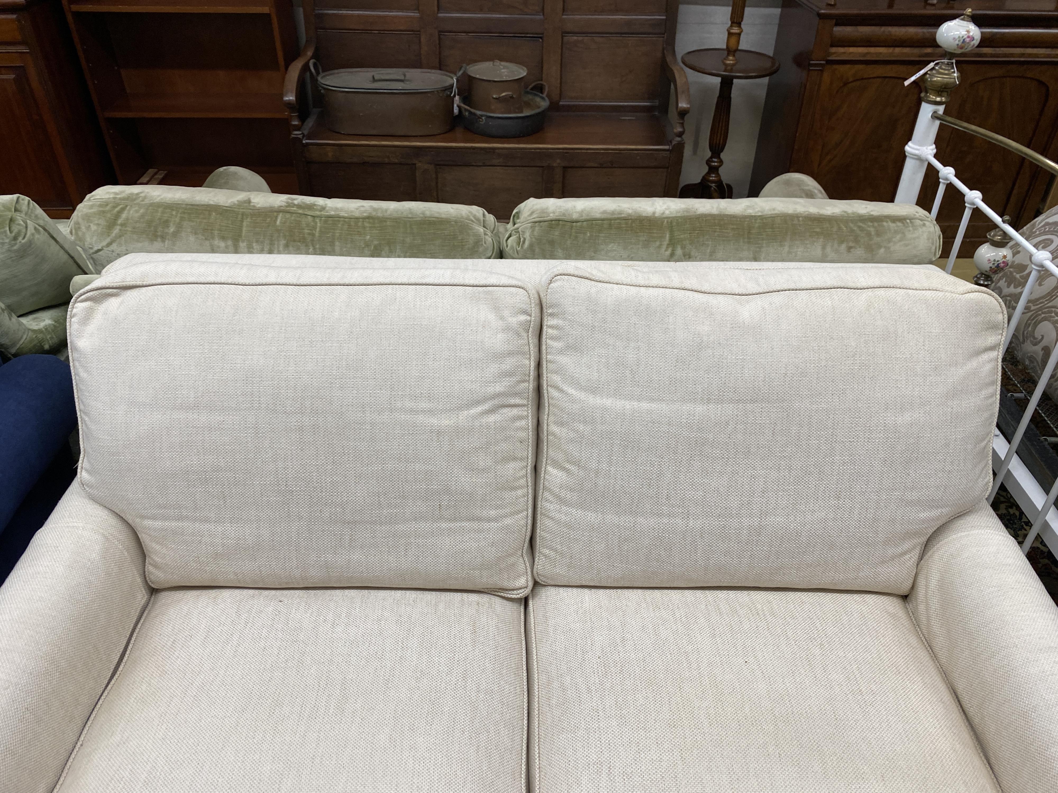 A Wesley Barrell cream fabric metal action two seater sofa bed, width 160cm, depth 96cm, height 82cm